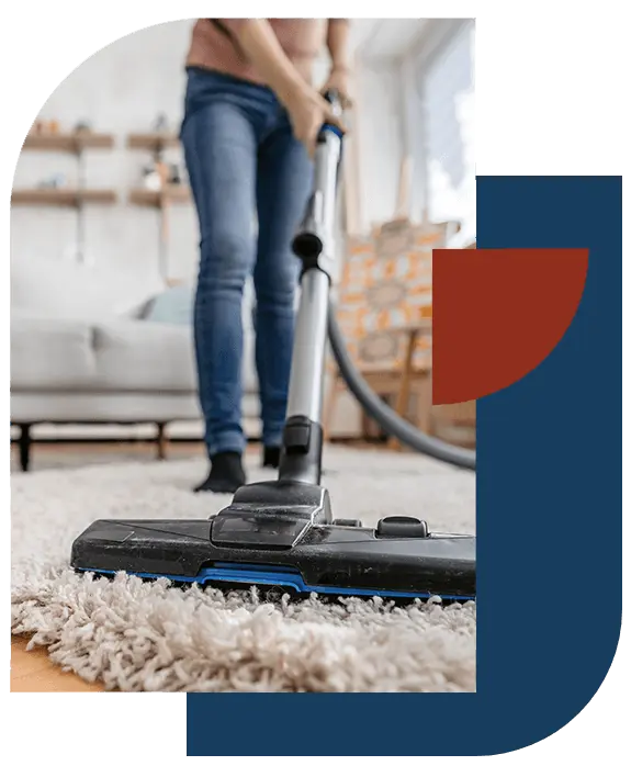 Vacuuming a rug in a home served by our New Orleans cleaning company