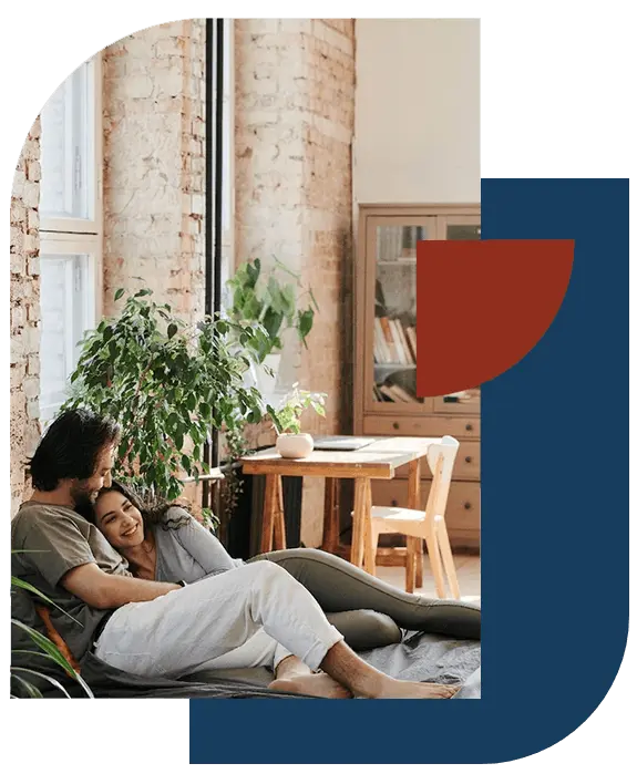 Couple relaxing on a sofa in a clean, tidy living room